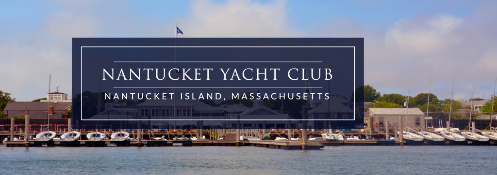 View of Nantucket Yacht Club marina in Nantucket, Massachusetts, with sailboats docked along the waterfront, clubhouse buildings, and a blue sky in the background. Text overlay reads “Nantucket Yacht Club, Nantucket Island, Massachusetts.”.